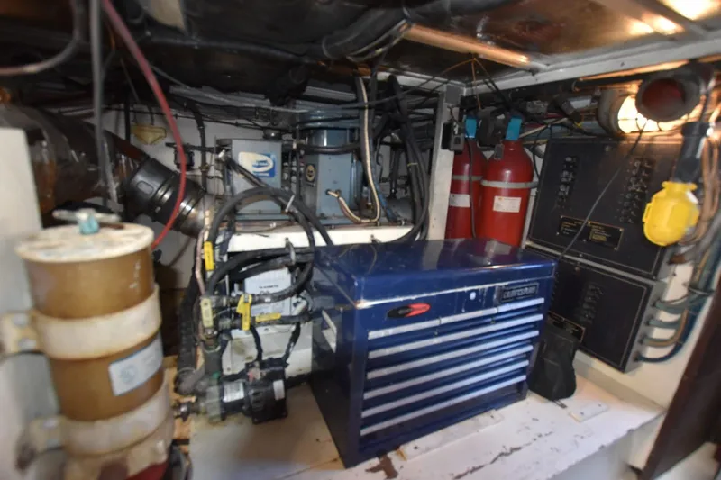 Slide: The Image of Engine room of 1983 Hatteras 50 Convertible yacht with equipment and control panels. - 30