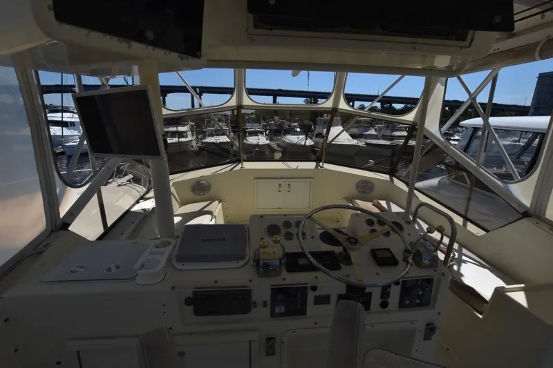 Slide: The Image of Interior view of 1983 Hatteras 50 Convertible yacht cockpit with steering wheel and controls. - 6