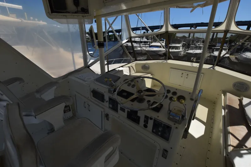 Slide: The Image of Interior view of 1983 Hatteras 50 Convertible yacht cockpit with steering wheel and controls. - 7
