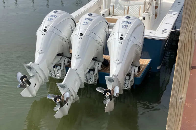 Slide: The Image of Triple Yamaha 350 V6 outboard engines on a 2027 Regulator 35 boat, docked in water. - 12