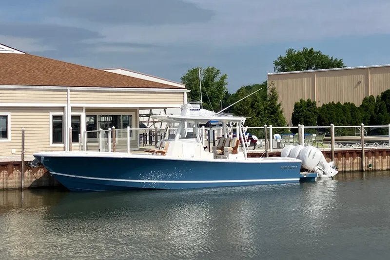 The Image of 2027 Regulator 35 boat docked by a waterfront building. - 0