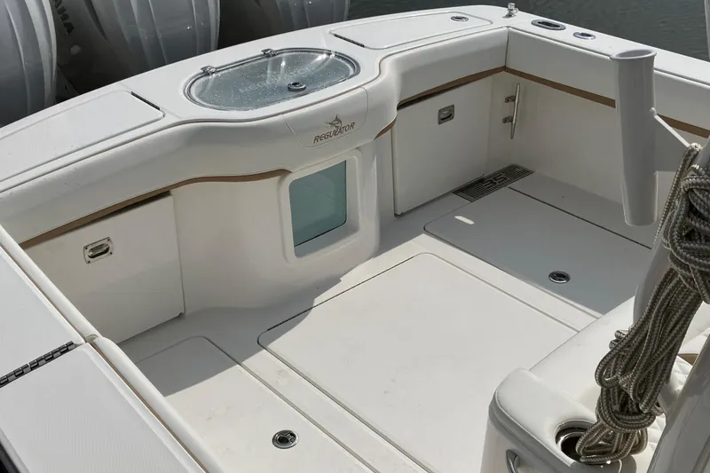 Slide: The Image of 2027 Regulator 35 boat deck with storage compartments and rope, showcasing sleek design. - 8