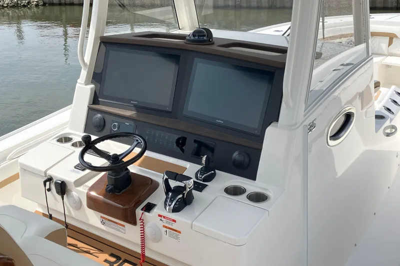 Slide: The Image of Helm of 2027 Regulator 35 boat with dual screens and steering wheel. - 9