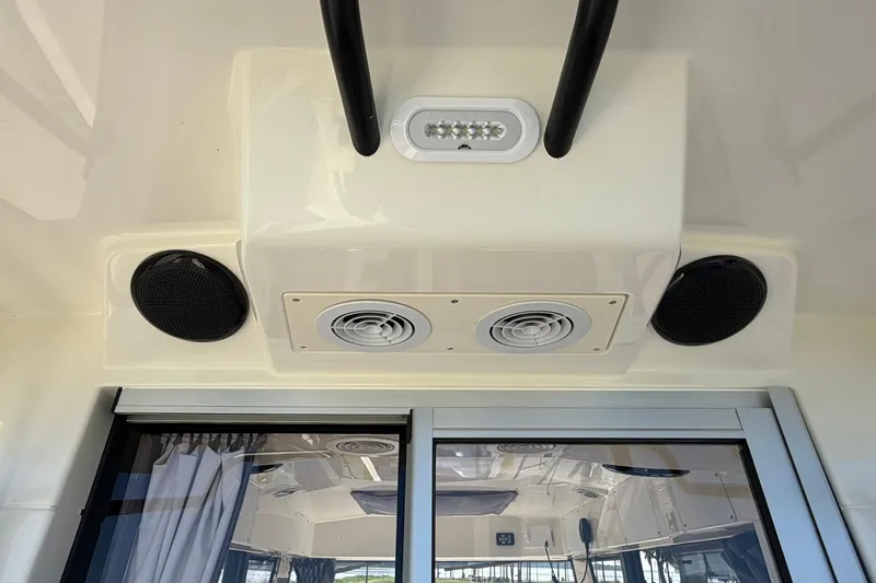 Slide: The Image of 2025 Bayliner Trophy T23 Pilothouse interior ceiling with speakers and ventilation system. - 53