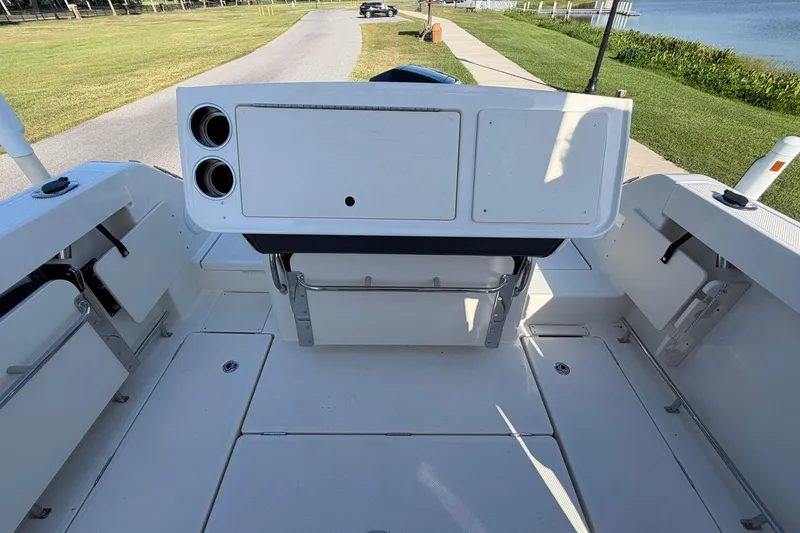 Slide: The Image of 2025 Bayliner Trophy T23 Pilothouse boat interior with seating and storage compartments. - 47