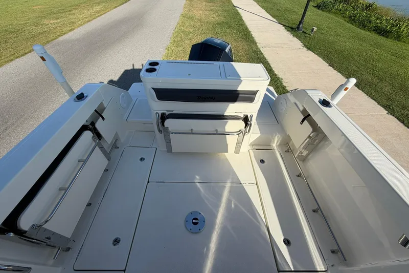 Slide: The Image of 2025 Bayliner Trophy T23 Pilothouse boat deck with seating and storage compartments. - 39