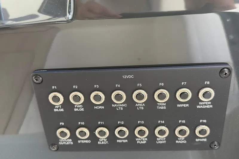Slide: The Image of Control panel of 2025 Bayliner Trophy T23 Pilothouse with labeled switches and outlets. - 26