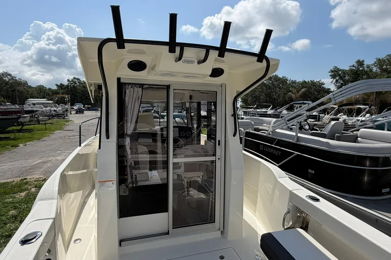 Slide: The Image of 2025 Bayliner Trophy T23 Pilothouse boat with sleek design and spacious cockpit. - 13