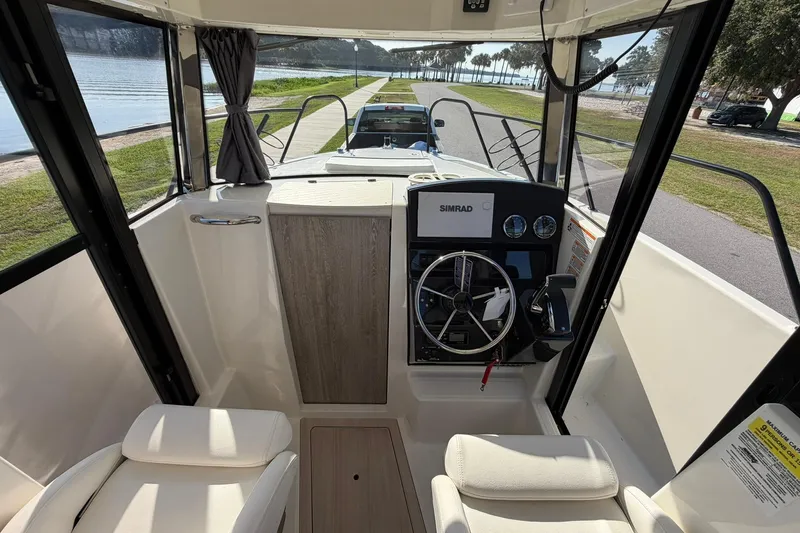 Slide: The Image of Interior view of 2025 Bayliner Trophy T23 Pilothouse with steering console and seating. - 20