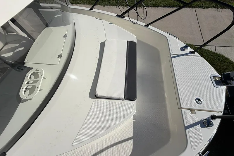 Slide: The Image of 2025 Bayliner Trophy T23 Pilothouse boat deck with seating and storage compartments. - 4