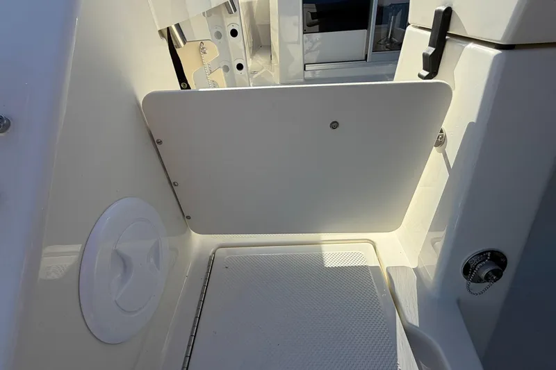 Slide: The Image of 2025 Bayliner Trophy T23 Pilothouse interior detail with storage compartment and latch. - 50