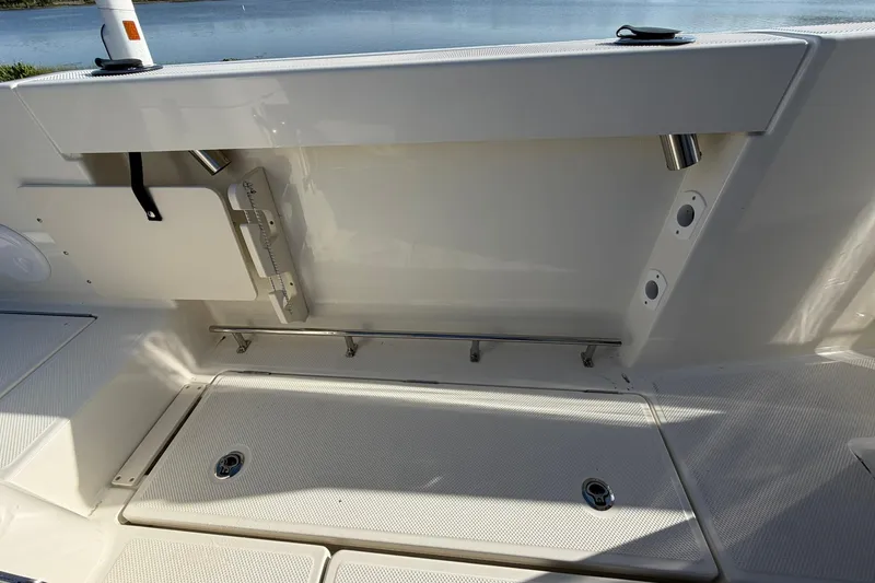 Slide: The Image of 2025 Bayliner Trophy T23 Pilothouse deck with storage compartments and rod holders. - 43