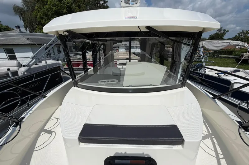 Slide: The Image of 2025 Bayliner Trophy T23 Pilothouse boat with sleek design and spacious deck area. - 5