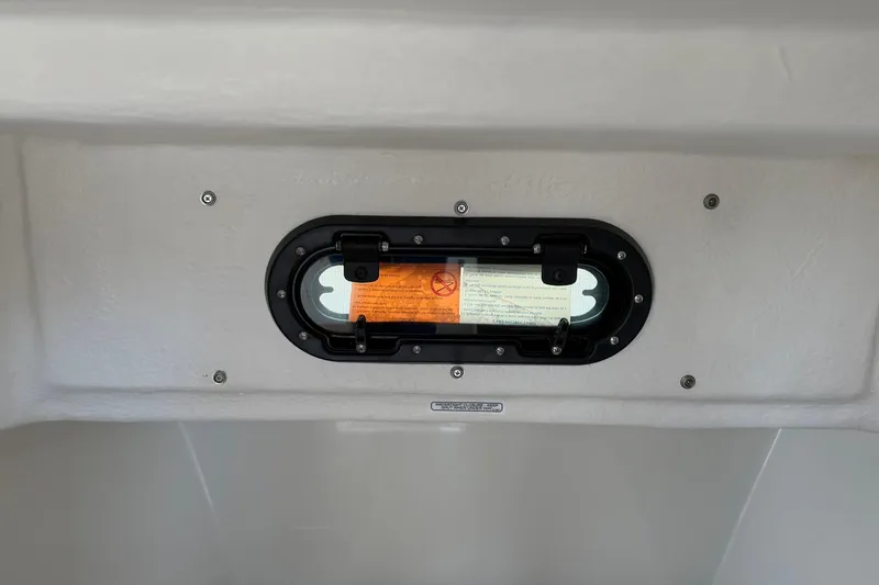 Slide: The Image of 2025 Bayliner Trophy T23 Pilothouse interior window detail with safety instructions. - 32