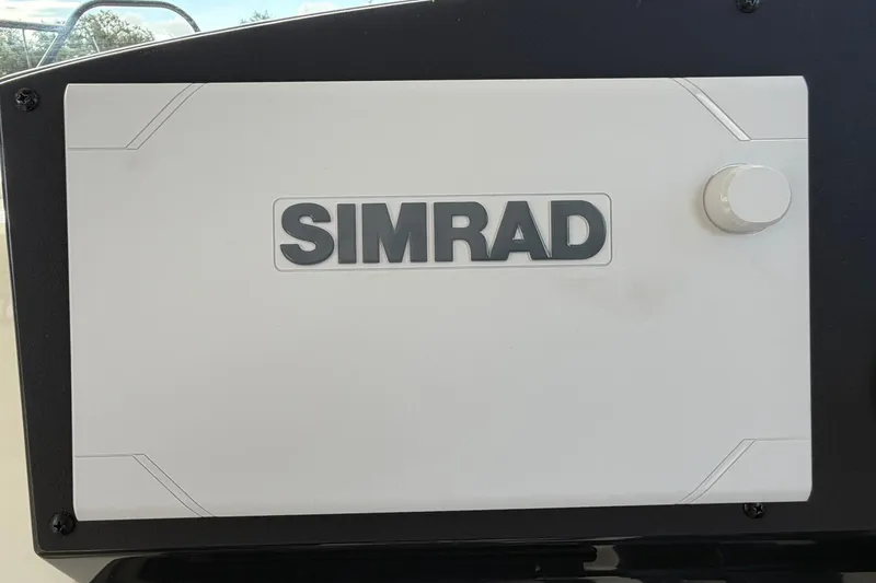 Slide: The Image of Simrad navigation system on 2025 Bayliner Trophy T23 Pilothouse boat dashboard. - 24