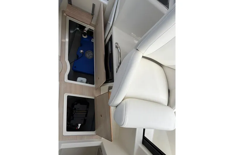 Slide: The Image of 2025 Bayliner Trophy T23 Pilothouse interior storage compartments and seating detail. - 38