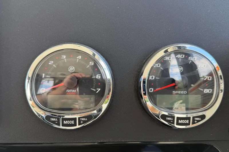 Slide: The Image of Dashboard gauges of 2025 Bayliner Trophy T23 Pilothouse, showing RPM and speed. - 28