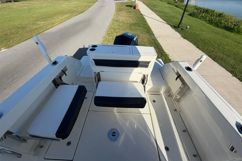 Slide: The Image of 2025 Bayliner Trophy T23 Pilothouse boat interior with seating and storage compartments. - 40