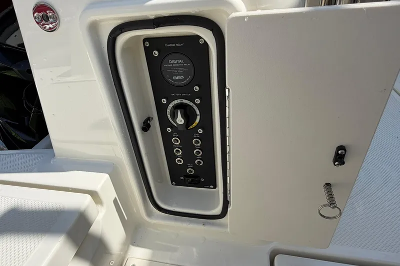 Slide: The Image of Control panel of 2025 Bayliner Trophy T23 Pilothouse boat, featuring battery switch and digital relay. - 62