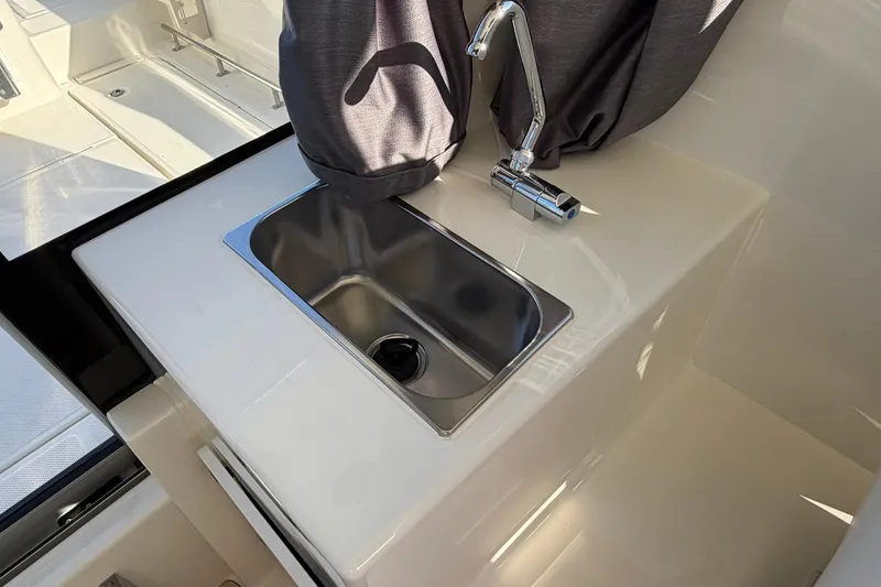 Slide: The Image of Compact sink and faucet in 2025 Bayliner Trophy T23 Pilothouse boat interior. - 18