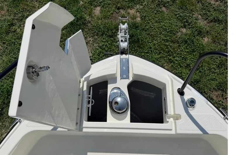 Slide: The Image of Bayliner Trophy T23 Pilothouse 2025 anchor locker with open hatch, showcasing marine hardware. - 3
