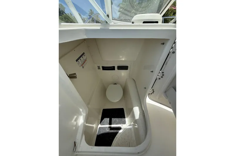 Slide: The Image of Interior view of 2018 World Cat 255 DC boat's compact marine toilet area. - 13
