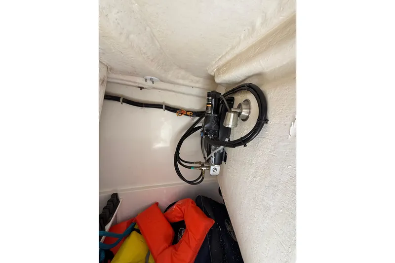 Slide: The Image of 2018 World Cat 255 DC boat interior showing wiring and life jackets. - 14