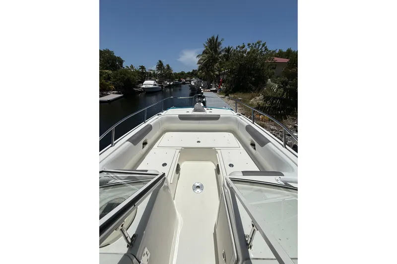 Slide: The Image of 2018 World Cat 255 DC boat on a serene waterway, surrounded by lush greenery. - 9