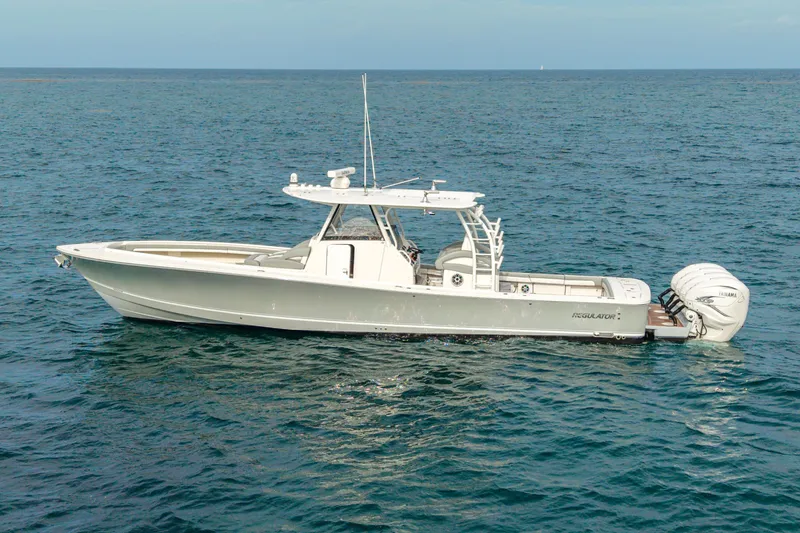The Image of 2022 Regulator 41 boat on open sea with triple Yamaha outboard engines. - 1