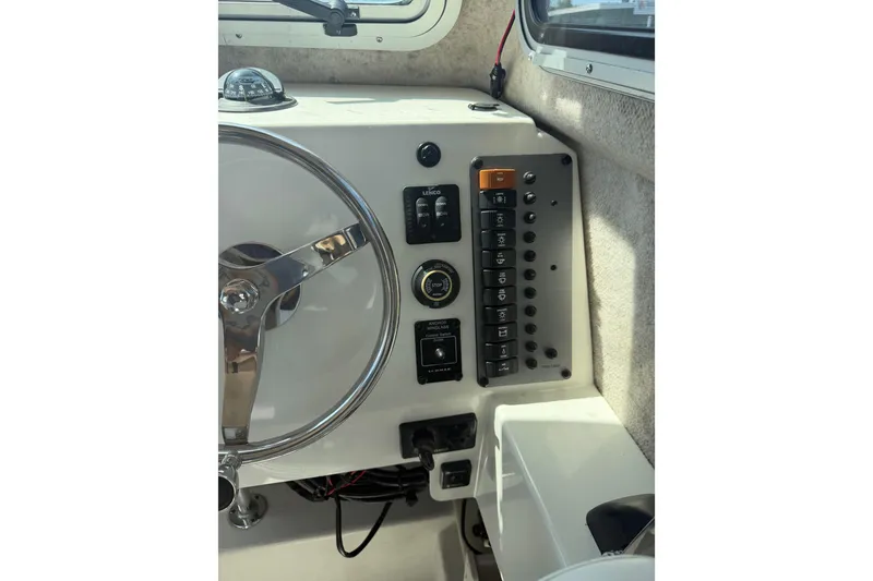 Slide: The Image of Steering wheel and control panel of 2019 Parker 2320 SL Sport Cabin boat. - 10