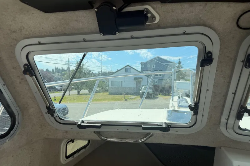 Slide: The Image of Interior view from a 2019 Parker 2320 SL Sport Cabin boat, showing the front window. - 13