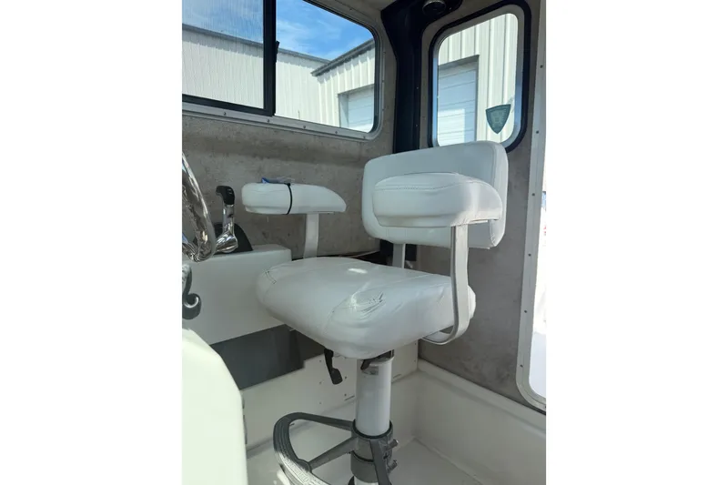 Slide: The Image of Interior of 2019 Parker 2320 SL Sport Cabin with white captain's chair and windows. - 15