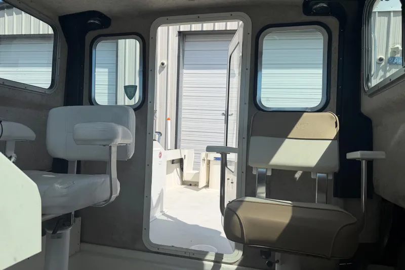 Slide: The Image of Interior view of a 2019 Parker 2320 SL Sport Cabin boat with seating and windows. - 16