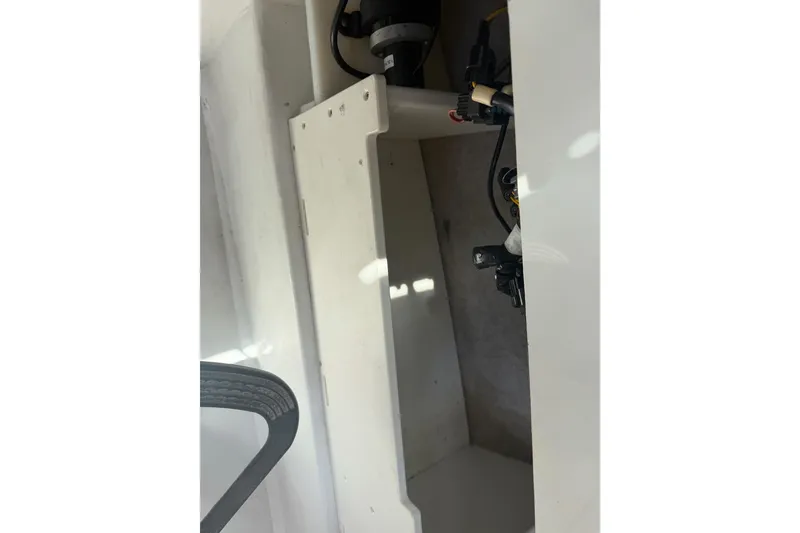 Slide: The Image of Interior view of a 2019 Parker 2320 SL Sport Cabin boat, showcasing storage compartment. - 20