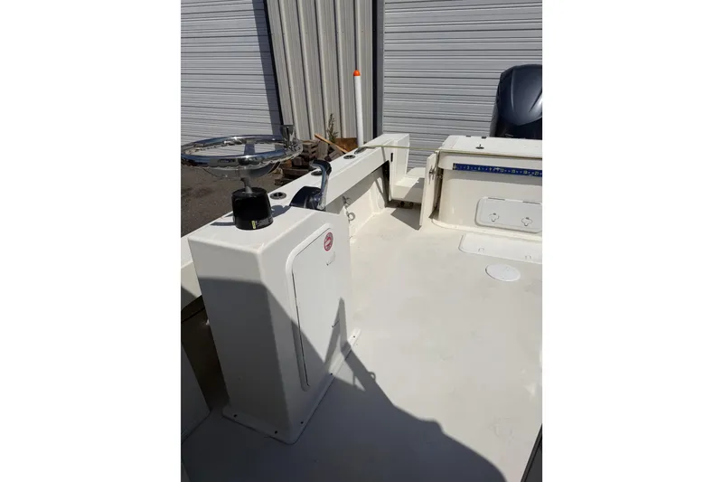 Slide: The Image of 2019 Parker 2320 SL Sport Cabin boat interior with fishing rod holder and storage compartment. - 23
