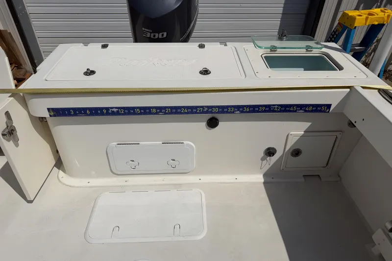 Slide: The Image of 2019 Parker 2320 SL Sport Cabin boat deck with Yamaha 300 engine and measuring tape. - 24