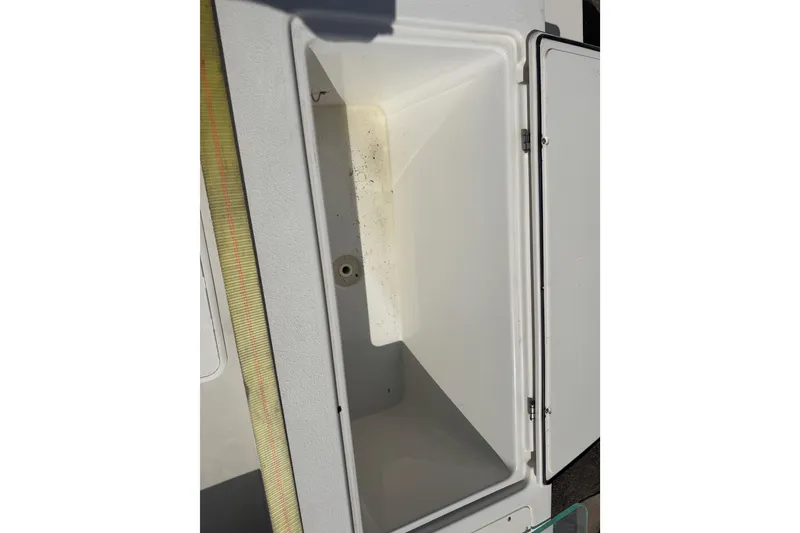 Slide: The Image of Open storage compartment on a 2019 Parker 2320 SL Sport Cabin boat. - 26