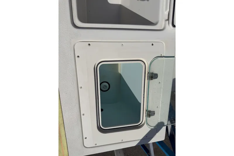 Slide: The Image of 2019 Parker 2320 SL Sport Cabin storage compartment with open glass door. - 27