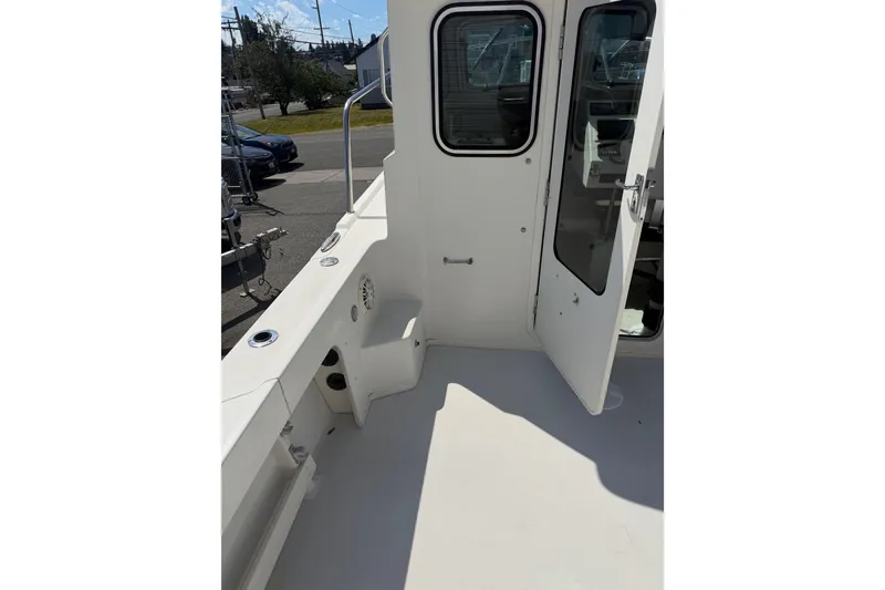 Slide: The Image of 2019 Parker 2320 SL Sport Cabin boat deck with open cabin door. - 29