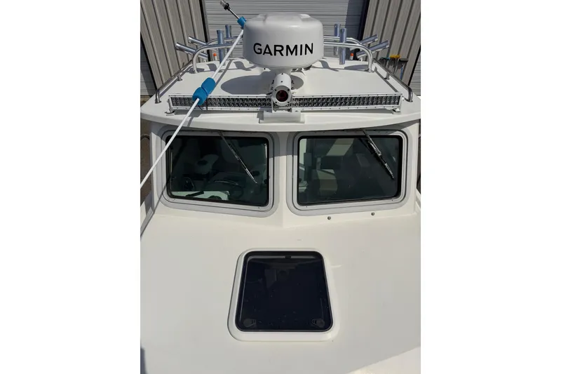 Slide: The Image of 2019 Parker 2320 SL Sport Cabin boat with Garmin radar on the roof. - 3