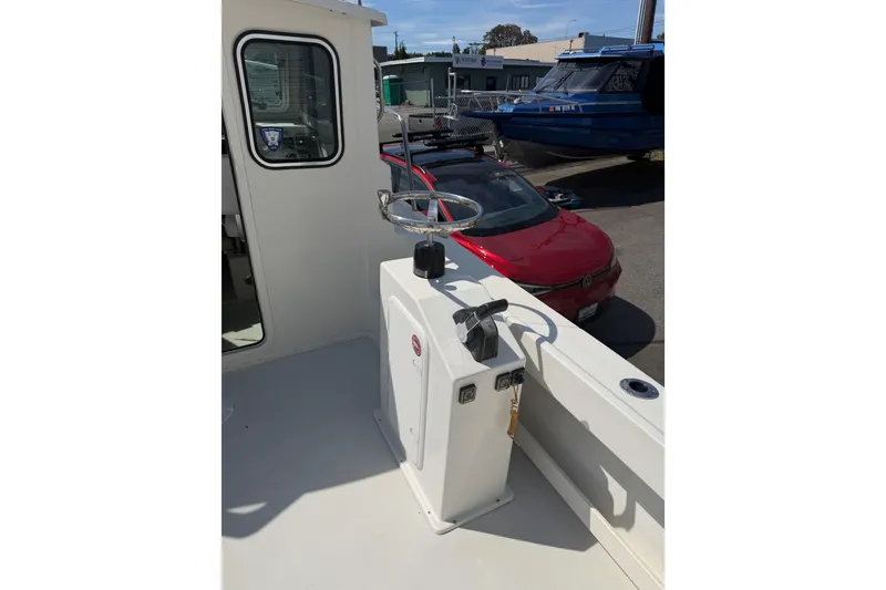 Slide: The Image of 2019 Parker 2320 SL Sport Cabin boat deck with steering wheel and controls. - 31