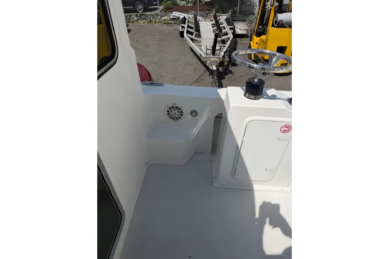 Slide: The Image of 2019 Parker 2320 SL Sport Cabin boat interior with steering wheel and storage compartment. - 32