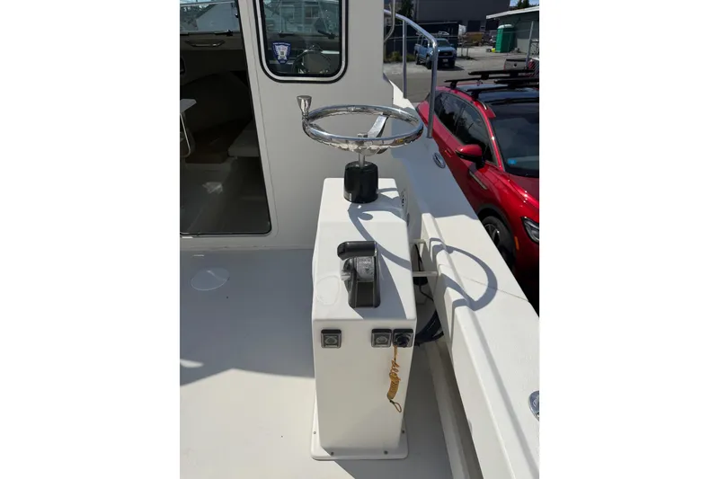 Slide: The Image of 2019 Parker 2320 SL Sport Cabin boat helm with steering wheel and controls. - 34
