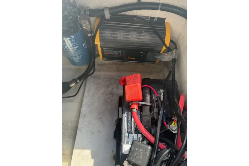 Slide: The Image of Battery and charger setup in a 2019 Parker 2320 SL Sport Cabin boat. - 37