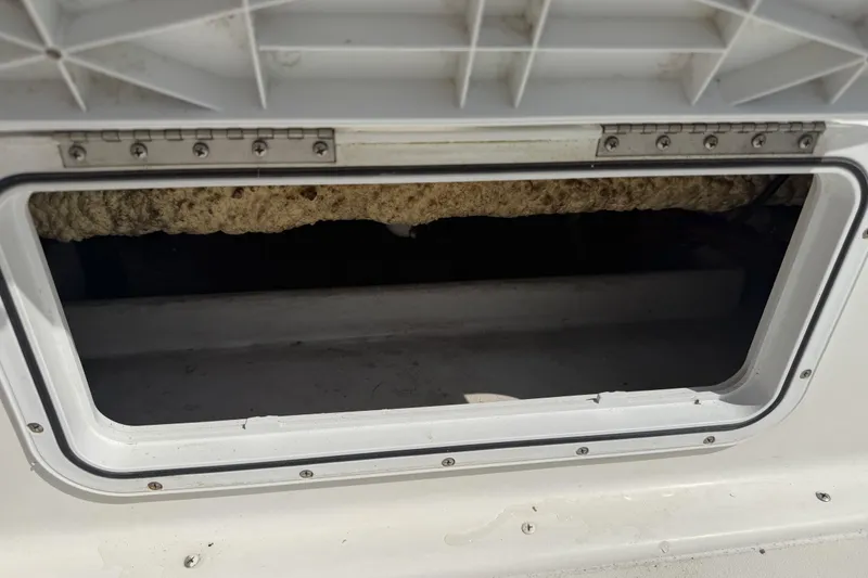 Slide: The Image of Open hatch on a 2019 Parker 2320 SL Sport Cabin boat, showing interior details. - 38