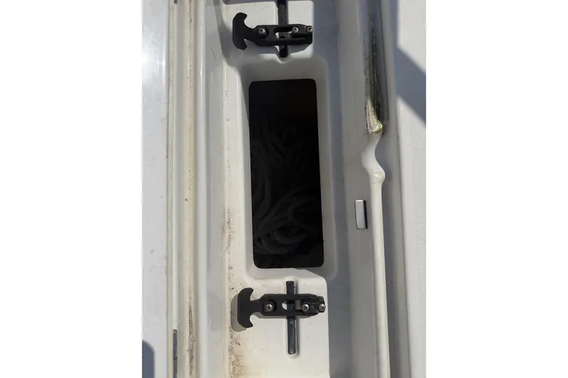 Slide: The Image of Storage compartment on a 2019 Parker 2320 SL Sport Cabin boat, featuring rope storage. - 42