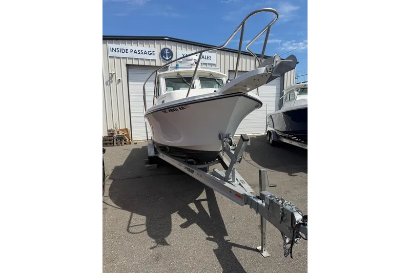 Slide: The Image of 2019 Parker 2320 SL Sport Cabin boat on trailer outside dealership. - 5