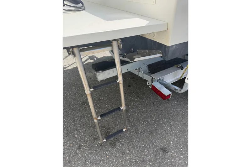 Slide: The Image of 2019 Parker 2320 SL Sport Cabin boat ladder and trailer detail. - 50