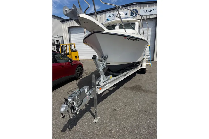 Slide: The Image of 2019 Parker 2320 SL Sport Cabin boat on trailer outside yacht storage facility. - 6