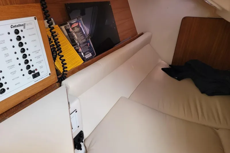 Slide: The Image of Interior of a 2006 Catalina 310 yacht with control panel and white seating. - 10